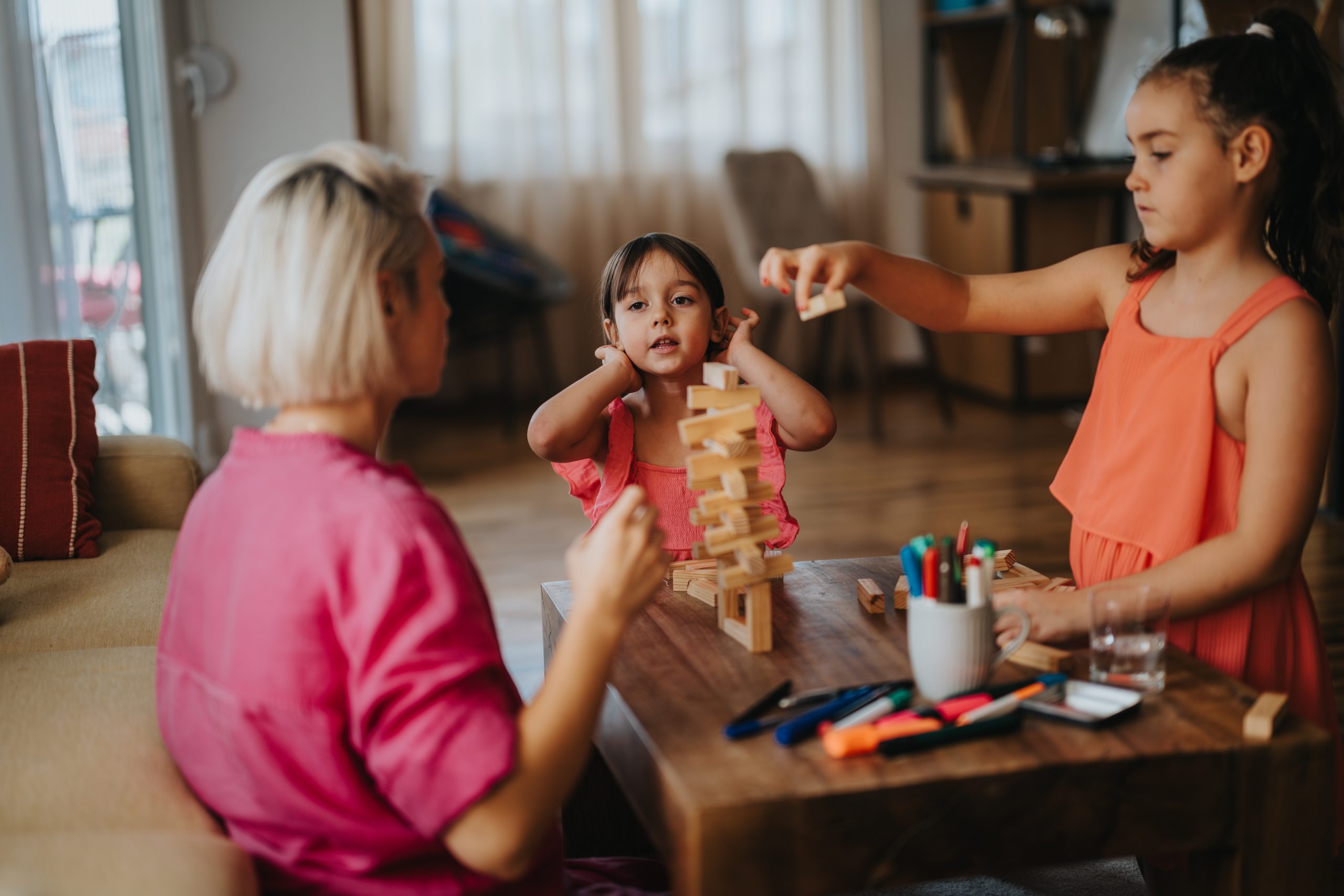 a woman playing jenga with her foster children