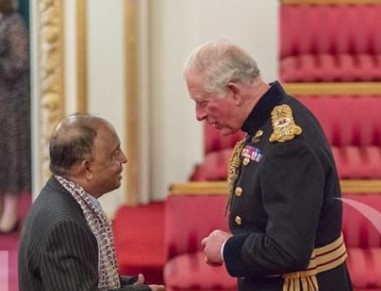 Engagement Officer Emdad receiving his MBE from King Charles III